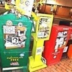 Festive DigBoston newspaper box with other newspaper boxes