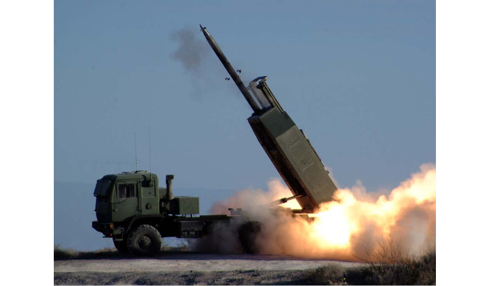 The High Mobility Artillery Rocket System fires the Army's new guided Multiple Launch Rocket System during testing at White Sands Missile Range. 11 January 2005. US Army photo. Public Domain.